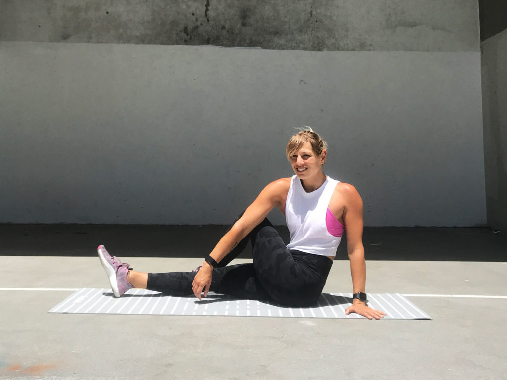 Athlete performing dynamic stretches before a workout.